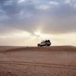 Adventure_Desert Safari_Car on dune sunset