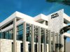 Modern white hotel with stone accent wall and large glass windows under a blue sky; sign reads HOTEL PREKO