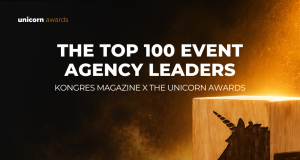 Hero banner announcing 'The Top 100 Event Agency Leaders' by Kongres Magazine x The Unicorn Awards with a glowing wooden unicorn block on the right.