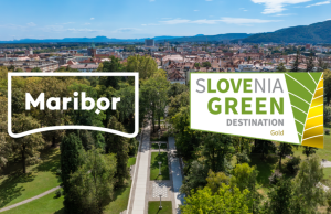 Aerial view of a Slovenian town with two overlapping logos: ‘Maribor’ on the left and ‘Slovenia Green Destination Gold’ on the right, set over a park and cityscape backdrop.